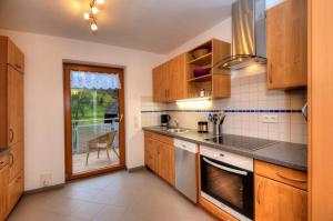 a kitchen with a sink and a stove at Dischhansenhof in Glottertal