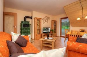 a living room with a couch and a table at Dischhansenhof in Glottertal