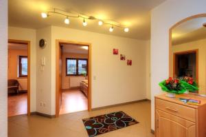a living room with a hallway with a mirror and a table at Dischhansenhof in Glottertal