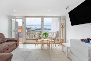 a living room with a couch and a table at Beach House el Poris 2 in Poris de Abona