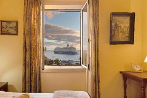 a window with a cruise ship in the water at Bela Sao Tiago 36 in Funchal