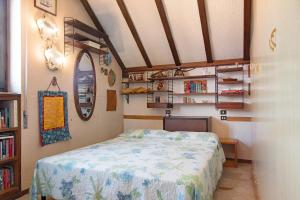 a bedroom with a bed and a book shelf at L'attico Con Terrazza Vista Lago in Laveno-Mombello