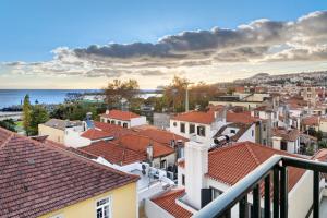 a view of the roofs of a city at Bela Sao Tiago 36 in Funchal