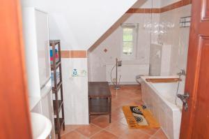 a bathroom with a sink and a bath tub at Ferienwohnung Alte Schule in Vetschau +10 photos