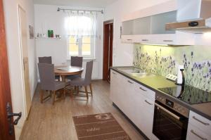 a kitchen with a table and a dining room at Ferienwohnung Alte Schule in Vetschau