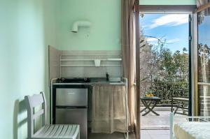 a kitchen with a sink and a table and a window at Old Boat double studio 5 in Nikiana +12 photos