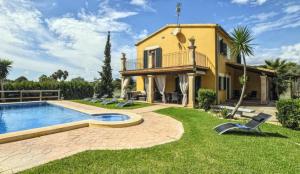 a villa with a swimming pool and a house at Ines in Inca