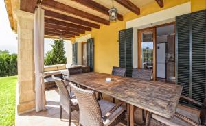 a wooden table and chairs on the patio of a house at Ines in Inca