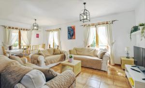 a living room with two couches and a tv at Ines in Inca