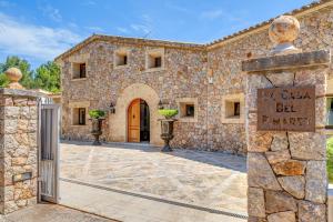 a stone building with a gate in front of it at Casa Del Pinaret in Port de Pollensa