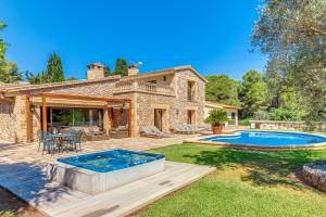 a backyard with a swimming pool and a house at Casa Del Pinaret in Port de Pollensa