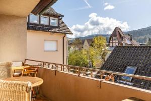 a balcony with a view of a house at Hirschturmblick in Zell am Harmersbach