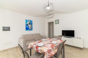 a living room with a table and a couch at Casa Virgi vista mare in Budoni