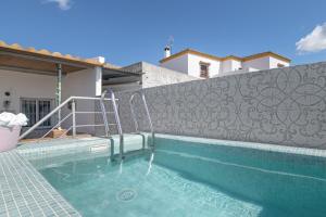 a swimming pool in front of a house at Casa Rocio in Barrio Nuevo