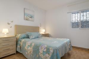 a bedroom with a bed and a dresser and a window at Casa Rocio in Barrio Nuevo +18 photos