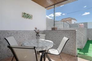 a table and chairs on the balcony of a house at Casa Rocio in Barrio Nuevo
