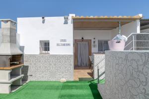 a view of a house with a green lawn at Casa Rocio in Barrio Nuevo