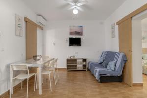 a living room with a dining room table and a couch at Casa Rocio in Barrio Nuevo