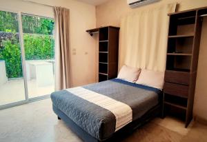a bedroom with a bed and a large window at Casa Maya Villa with Private Pool Bar and Parking Merida in Mérida +20 photos