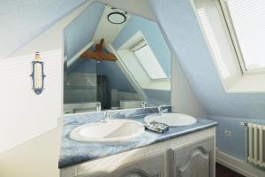 a bathroom with a sink and a mirror at Gite Cours Péan in Châteaugiron +22 photos