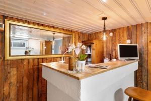 a room with a counter with a television and a mirror at Sleep And Go in Mundelsheim +20 photos