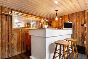 a kitchen with wooden walls and a bar with stools at Sleep And Go in Mundelsheim