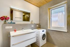 a bathroom with a washing machine and a sink at Ferienhäuser Stickel in Freudenstadt +38 photos