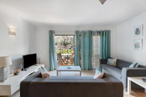a living room with a couch and a tv at Blue Dream Pebble Beach in San Miguel de Abona