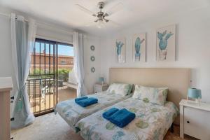 a bedroom with a bed with blue pillows on it at Blue Dream Pebble Beach in San Miguel de Abona +19 photos