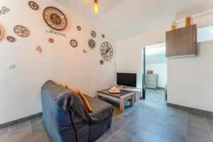 a living room with a couch and a tv at Gite en Campagne Valentin in Avignon