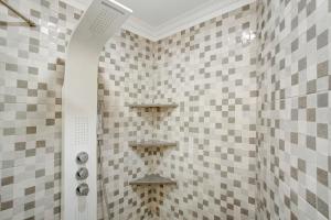 a shower in a bathroom with checkered tiles at Alegria Dream Home in Funchal +20 photos