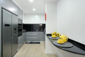 a kitchen with a counter with yellow mugs on it at Alegria Dream Home in Funchal