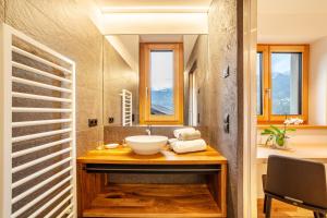 a bathroom with a sink and a mirror at Huetterhof Apartement Winter in Caines +13 photos