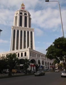 a large building with a tower with a clock on it at Boulevard Apartments in Itʼkhvisi