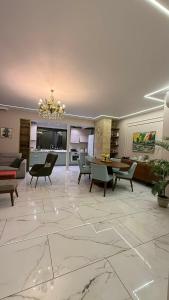 a living room with a chandelier and a living room at Boulevard Apartments in Itʼkhvisi