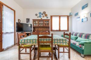 a living room with a table and a couch at Maya in Villasimius