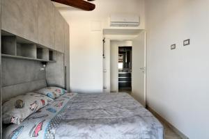 a bedroom with a bed with a concrete headboard at Pasquale Home Holiday in Bari Sardo