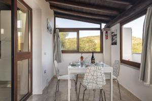a dining room with a table and chairs and a window at Pasquale Home Holiday in Bari Sardo +13 photos