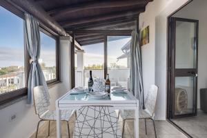 a dining room with a white table and chairs at Pasquale Home Holiday in Bari Sardo