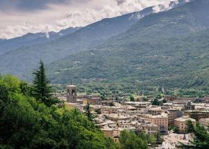 a view of a city with mountains in the background at Foresteria al Cantun in Sondrio