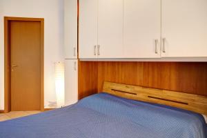 a bedroom with a bed and white cabinets at Foresteria al Cantun in Sondrio