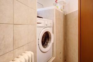 a washer and dryer in a small bathroom at Foresteria al Cantun in Sondrio