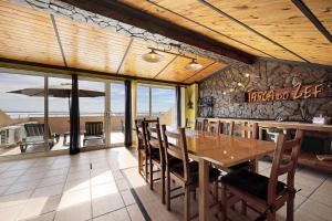 a dining room with a wooden table and chairs at My Friendly House in Lagos
