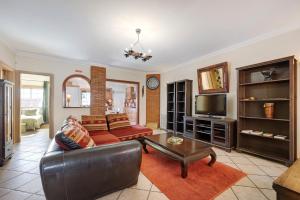 a living room with a couch and a tv at My Friendly House in Lagos