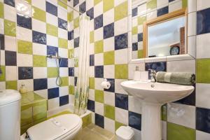 a bathroom with a sink and a toilet at My Friendly House in Lagos +29 photos