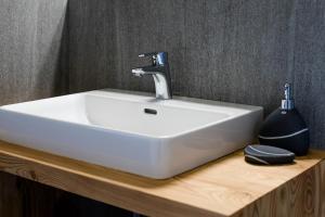 a white sink on a wooden counter in a bathroom at Vernalhof Apt Panorama in Sluderno
