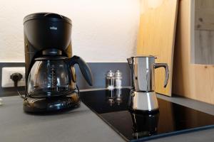 a coffeemaker and a coffee pot on a counter at Ansitz Baumannhof Apt Mitte in Falzes