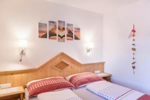 a bedroom with a bed with two pillows at Apart Joachim in Fügen