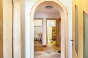 a hallway with an archway leading to a bathroom at Apart Joachim in Fügen