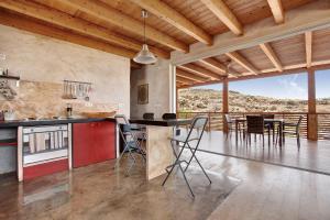 a kitchen with a table and chairs in a room at Tayu Eco Villa in Villaverde